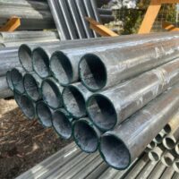 Stack of galvanised steel strainer posts